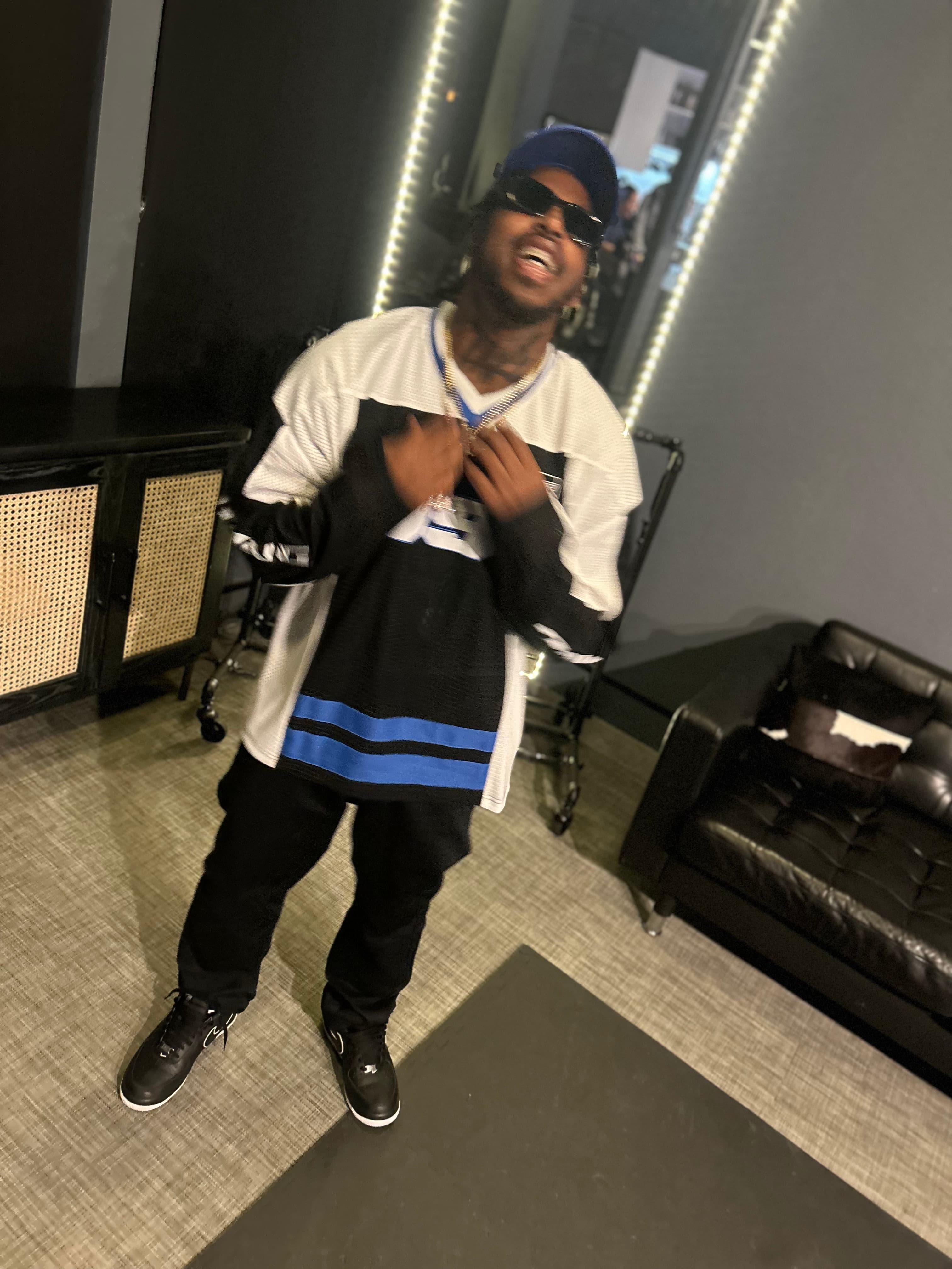 1TakeQuan posing in a striped jersey, full length