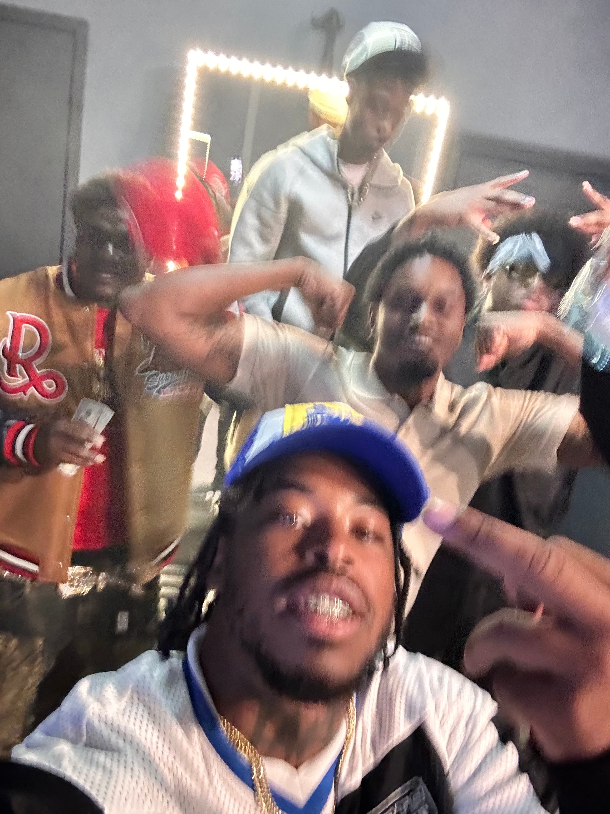 Crew selfie in an LED-lit room, closer